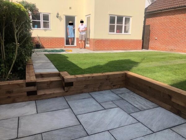 Indian Sandstone Patio with Sleeper Retaining Walls in Ongar, Essex