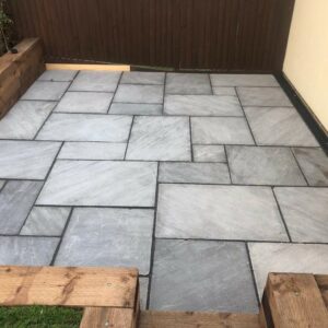 Indian Sandstone Patio with Sleeper Retaining Walls in Ongar, Essex