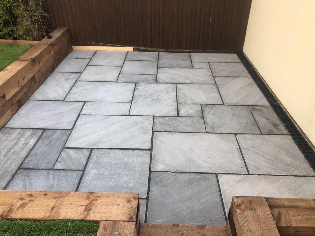 Indian Sandstone Patio with Sleeper Retaining Walls in Ongar, Essex