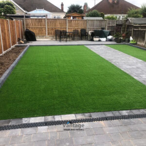 Tegula Paved Driveway and Patio with Flower Beds and Artificial Lawn in Chelmsford