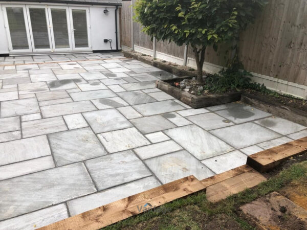 Tiered Sandstone Patio with Retaining Sleeper Walls in Chelmsford