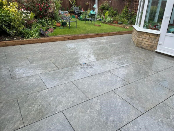 Patio with Porcelain Slabs, Railway Sleepers and Granite Pathway in…