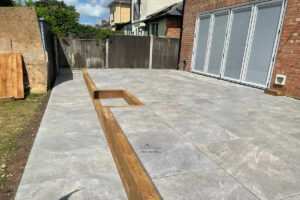 Tegula Paved Driveway with Fencing and Porcelain Tiled Patio in Chelmsford