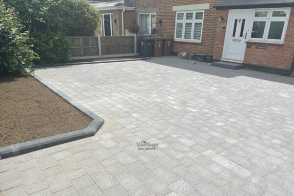 Tegula Paved Driveway with Fencing and Porcelain Tiled Patio in Chelmsford