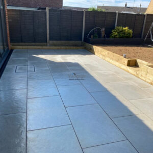 Hammered Porcelain Tiled Patio with Retaining Sleeper Wall in Braintree,…