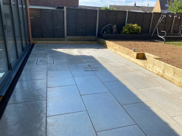 Hammered Porcelain Tiled Patio with Retaining Sleeper Wall in Braintree,…