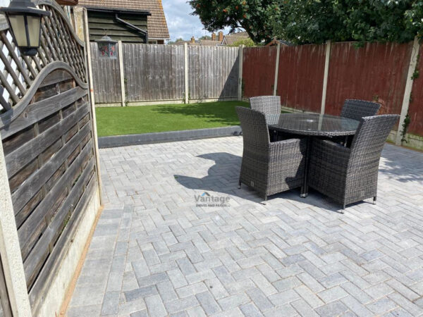 Charcoal Block Paved Patio with Raised Artificial Lawn in Witham,…