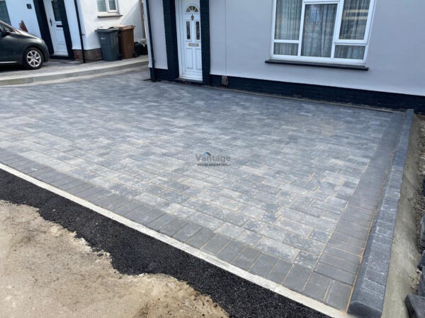 Driveway with Silver Grey Tegula Paving and Bull-Nose Kerbing in…